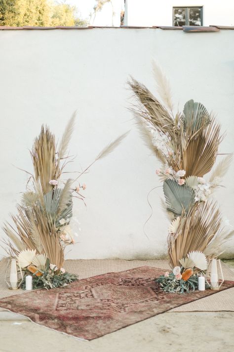 wedding alter with pampas grass, dried palm leafs, roses and candles. Vintage rug accent with a romantic desert vibe. elopement, photography Romantic Wedding Alter, Pampas Grass Garland, Boho Wedding Altar, Roses And Candles, Palm Leaf Decor, Wedding Alter, Palm Wedding, Wedding Alters, Photoshoot Backdrops