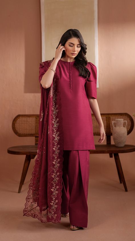 Adelia  - A delicate blend of traditional and contemporary, this short shirt in Burgundy boasts a buttoned neckline and puff sleeves. It is paired with a flared shalwar. Outfit is paired with colorful heavy embroidered medium silk dupatta featuring a vibrant four-sided organza embroidered border. Short Frock With Tulip Shalwar, Short Shirt With Shalwar, Shalwar Design, Bts Bracelet, Simple Dress Casual, Short Frock, Aesthetic Collection, Flowers Quotes, Pakistani Clothes