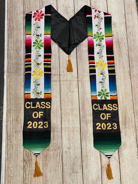 You will receive the exact stole you see on the listing's picture. Its an authentic well made Mexican Serape Graduation Stoles. The serape is handmade delicately with flower embroidery from Mexico. These stoles are a perfect addition to your graduation outfit. No two stoles are the same. Show off your pride with this unique embroidered stole made by very talented Mexican artisans. These stoles sell out quickly! If you see one you love, purchase it. Message me for express shipping options. Visit Mexican Graduation, Graduation Leis Diy, Graduation Stoles, Graduation Cap Decoration Diy, Graduation Sash, Mexican Serapes, Graduation Stole, Graduation Cap Designs, Graduation Cap Decoration