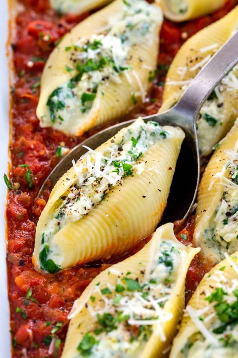 Stuffed shells recipe with spinach and three kinds of cheese! Ricotta, parmesan, and mozzarella pair nicely with a homemade sausage marinara sauce. #stuffedshells #italian #pasta Stuffed Shells With Spinach, Stuffed Shells With Meat, Recipe With Spinach, Newfoundland Recipes, Spinach Stuffed Shells, Sausage Marinara, Stuffed Shells Ricotta, Shells Recipe, Cheese Stuffed Shells