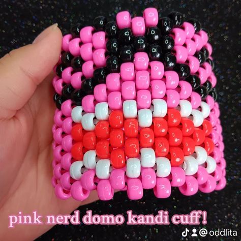 pink nerd domo kandi cuff! 🩷🌸❤️🌸🧡🌸💛🌸💚🌸💙🌸💜 🎀 SOLD! ♡ check out my page for tons of other kandi + jewelry pics >:3 ♡ handmade with love by me! ♡ freebies with every order! thank you for your support <33 🩷🌸❤️🌸🧡🌸💛🌸💚🌸💙🌸💜 shares are greatly appreciated! you are helping me grow my small business <3 PLUR!! 🌈 #kandi #beadedbracelet #beadedbracelets #handmadejewelry #beadbracelets #jewelry #bracelets #kandicuff #domo #nerd #pinkdomo #2000s #2010s Domo Kandi, Kandi Jewelry, Jewelry Pics, Kandi Inspo, Diy Kandi Bracelets, Diy Kandi, Kandi Ideas, Kandi Cuff, Kandi Patterns