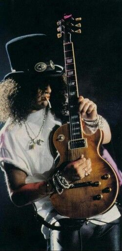 SLASH playing a les paul guitar and smoking, as always Slash Playing Guitar, Slash Poster, Slash Wallpaper, Slash Les Paul, Saul Hudson, Artist Film, Rockstar Aesthetic, Les Paul Guitars, Classic Rock And Roll