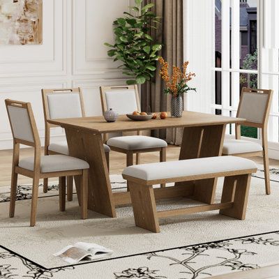 This Retro Dining Set, showcasing a unique fusion of vintage and rustic styles, is crafted from high-quality wood for durability. Its striking design features, including a trapezoidal table base and carved lines on chairs, offer a cozy ambiance in any dining space. Mercer41 Table Top Colour: Brown, Chair Colour: Natural Wood Wash, Table Base Colour: Natural Wood Wash | Mercer41 6-Piece Retro Dining Set Brown, Solid Wood | C111849575 | Wayfair Canada Studio Table, Flexible Seating, Dining Room Bar, Straight Lines, Rectangular Table, Formal Dining Room, Kitchen Dining Furniture, Simple Shapes, Table Base