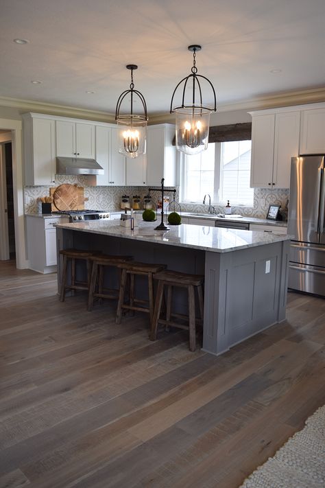 Gorgeous gray and brown hardwood floor with grey cabinets and gray lighting fixtures