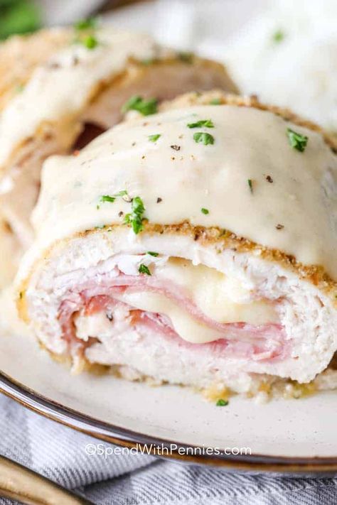 This Easy Chicken Cordon Bleu recipe is an easy baked main dish that can be made into a casserole as well. With breaded chicken wrapped around ham and Swiss cheese topped with a homemade creamy sauce it is a dinner party favorite. #spendwithpennies #chickencordonbleu #casserole #dinnerparty #bakedchickencordonbleu #chickenrecipe #maindish #easychickencordonbleurecipe Hobo Dinner, Baked Chicken Cordon Bleu, Easy Chicken Cordon Bleu, Cordon Bleu Recipe, Cordon Blue, Chicken Cordon Bleu Recipe, Stuffed Chicken Breast Spinach, Chicken Shawarma Recipe, Cheese Stuffed Chicken Breast