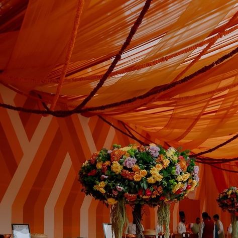 TheDesignCompanyByHennaArora on Instagram: "A mehendi, in an orange wonderland! 🧡 @manaviagarwal & @dhruv_bhatnagar  The #HighOnMD Mehendi was built around a vibrant colour palette, rich in warm orange tones, with hints of green & yellow. The tablescape was straight out of a fairytale, with bold blooms in vibrant hues. — Conceptualised & Executed by the ⭐️Team: Design Conceptualisation and Execution: @thedesigncompanyindia Florals: @thedesigncompanyindia  Wedding Planners: @panodramaevents — Wedding Decor | Wedding Florals | Wedding Planning | Indian Wedding | Luxury Wedding | Destination Wedding | Wedding Design | Event Planning | Mehendi Decor" Vibrant Colour Palette, Indian Celebration, Mehendi Decor, Florals Wedding, Team Design, Orange Decor, Wedding Luxury, Orange Tones, Boho Wedding Decorations