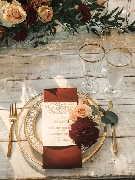 Burgundy gold and white wedding reception decoration Burgundy And Terracotta Wedding Table, Copper Table Setting Wedding, Terracotta Burgundy Gold Wedding, Burnt Orange Wedding Place Setting, Fall Wedding With Gold Accents, Terracotta And Gold Wedding Decor, Gold Rimmed Plate Table Setting, Gold Fall Wedding Decor, Rustic Fall Wedding Place Setting