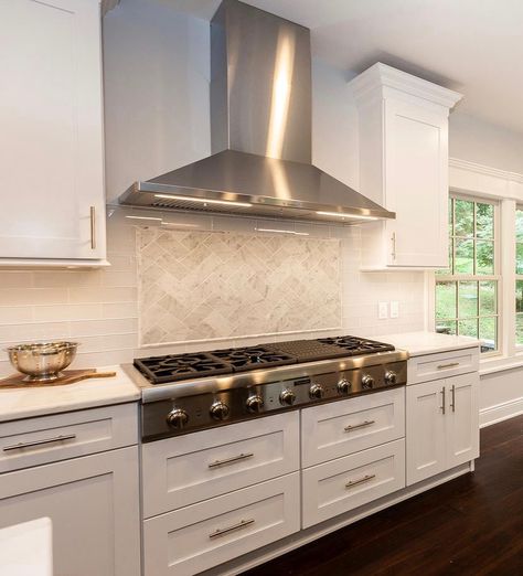 Sleek, stainless steel hoods are a great modern or classic design choice. The industrial feel and clean lines work well with contemporary kitchens, while the metallic element adds contrast and a modern touch to traditional kitchen décor. Click on the link to see photos of more kitchen vent hood ideas. https://www.kbconstructionnj.com/kitchen-vent-hood-designs-images-and-ideas/ White Kitchen Vent Hood, Modern Kitchen Stove, Kitchen Stove Design, Stainless Steel Hood Vent, Traditional Kitchen Decor, Kitchen Hood Ideas, Stove Range Hood, Stove Design, Home Ideas Kitchen