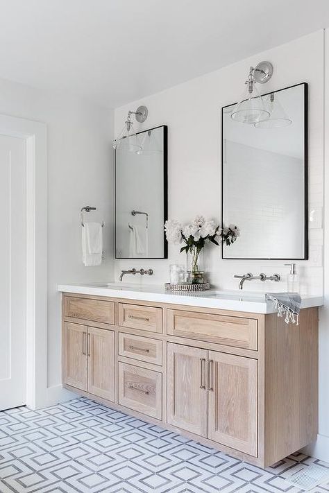 A brushed oak dual bath vanity sits on white and gray geometric floor tiles and is accented with nickel pulls and a white quartz countertop. Oak Bathroom Vanity, New House Bathroom, Oak Bathroom, Geometric Floor, Bathroom Farmhouse Style, Bad Inspiration, Master Bath Remodel, Upstairs Bathrooms, Bathroom Redo