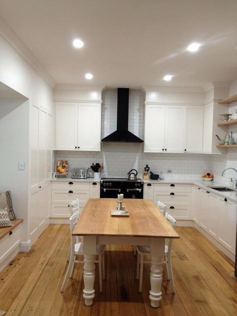 My kitchen!! Tasmanian oak floorboards || open timber shelving || white modern farmhouse kitchen || black Belling oven || black rangehood || rustic table || window seat || exposed faucet tap || undermount sink || london grey caesarstone || white shaker cabinetry || subway tiles || fully integrated dishwasher || dulux antique white|| Black Rangehood Kitchen, Exposed Rangehood Kitchen, White Kitchen Black Range, Black Appliances Kitchen White Cupboards Subway Tiles, Rangehood Kitchen, Kitchen Black Appliances, Farmhouse Kitchen Black, Black Sink Oak Worktop, Timber Shelving