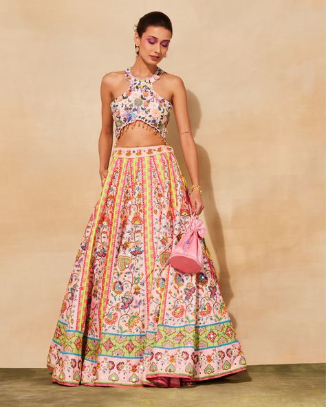 Featuring a blush pink lehenga in raw silk and tulle base with floral print. It is paired with a matching embroidered blouse and a potli bag. Unique Indian Bridal Lehenga, Blush Pink Lehenga, Modern Lehenga, Floral Print Lehenga, Lehenga And Blouse, Print Lehenga, Mirror Embroidery, Potli Bag, Indian Bridal Lehenga