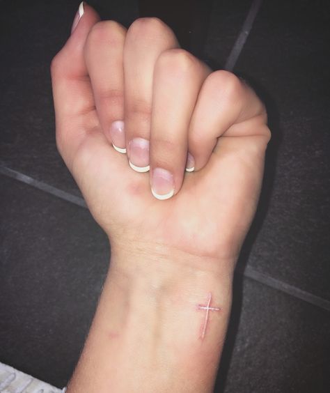 White Cross Tattoo on Wrist White Cross Tattoo, Cross Tattoo Wrist, White Tattoo Cross, Cross On Wrist, Faith Cross Tattoos, Cross Tattoo Meaning, Unique Cross Tattoos, Cross Tattoo On Wrist, Wrist Tattoos Girls