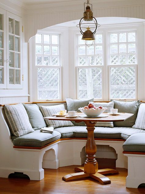 Another great space for a dream beach home.  Oil lantern light, bay window and around seating- really maximizes the space, and the stand for the table is beautiful. (I love the maple color as well)     I've always wanted a cozy breakfast space like this in a kitchen, it reminds me  of grandparent's .  Like the space beneath the seating to tuck your legs Kitchen Booth, Curved Kitchen, Kitchen Banquette, Banquette Seating, Kitchen Nook, Built In Bench, Dining Nook, Eat In Kitchen, Breakfast Nook