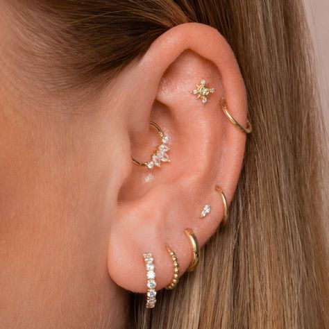 The ultimate ear stack staple - simple, classic and timeless. Our solid gold clicker hoops are super versatile cartilage earrings and can be worn in a wide range of piercing placements, including nose piercings. Sold as one single earring. Compatible with both our small and large charms. Inner diameter: 8mmGauge: 16g (1.2mm)Materials: 14k solid yellow gold Ear Curation Daith, Cute Ear Stacks, Daith Stud, Ear Piercings Gold, Minimalist Ear Piercings, Sparkly Crystals, Stackers Jewellery, Septum Piercings, Pretty Ear Piercings