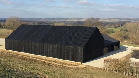 Macdonald Wright Architects has added a barn clad in black-stained boards to Caring Wood – a Kent country villa that is vying to be named the UK's House of the Year Black Houses, Rural Architecture, Wood Facade, Warehouse Design, Black Barn, Modern Barn House, Wood Architecture, Shed Homes, Barn Style House