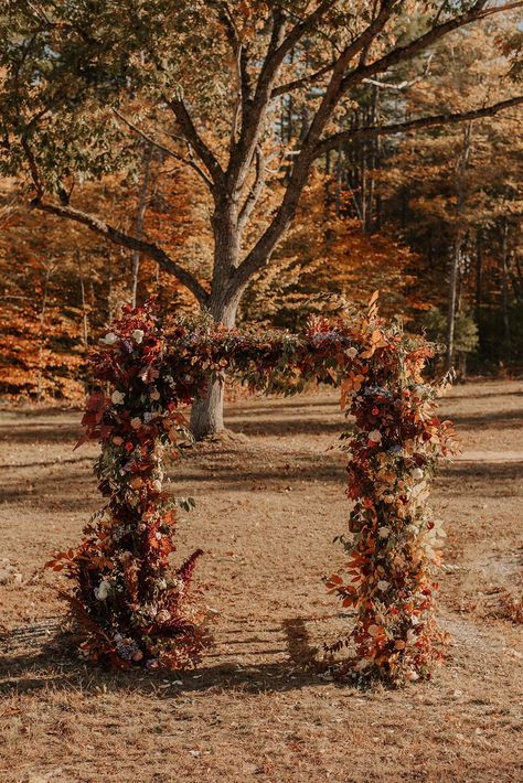 How stunning is this colorful floral arch for a fall elopement? We love the unique tones for the wooded Maine wedding venue. Check out more details from this day on the blog.