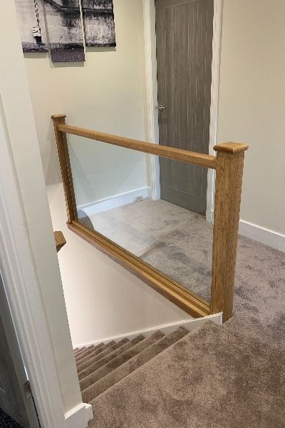 Upstairs Banister, Stair Bannister Ideas, Glass Landing, Glass Bannister, Hallway Coat Storage, Transformation Design, Landing Stairs, Stair Paneling, Oak Handrail