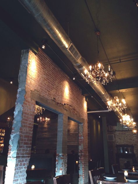 Distressed brick, tall ceilings, exposed duct work, hanging chandeliers. Exposed Ducked Work, Black Duct Work, Spiral Duct Exposed, Exposed Duct Work In Home, Exposed Ductwork Ceiling, Black Exposed Ceiling, Rustic Industrial Dining Room, Exposed Ductwork, Distressed Brick