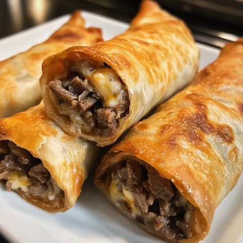 Philly Cheesesteak Egg Rolls are a delightful fusion of savory steak, melty cheese, and crisp egg roll wrappers. They’re not heavy or overly greasy either. I think they’re perfect for a game day snack or a fun party appetizer, and if you’re not a fan of bell peppers, feel free to omit them. They will still be undeniably delicious! If you’re looking for a crispy & savory treat that’s not overly greasy, you’ve come to the right place. When you take tender steak, gooey cheese, and wrap them in a Steak Egg Rolls, Philly Cheesesteak Egg Rolls, Egg Roll Wrapper, Chicken Dinner Ideas, Egg Roll Filling, Baked Turkey Wings, Steak Wraps, Quick Dinner Ideas, Chicken Stroganoff