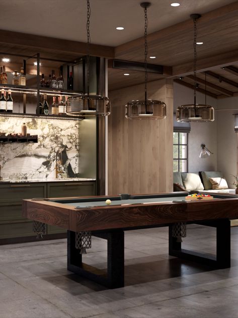 A special place is designated for the billiards room. It’s a separate space that can be divided into several zones for different leisure scenarios. The billiards table takes center stage. A wine fridge, mini kitchen for cocktail preparation, and custom bar counter create a space for heartfelt conversations over drinks. The gaming machine contrasts with the classic billiards table but speaks to the owners’ sense of humor. Bar Rec Room Ideas, Pool Table Room With Bar, Modern Games Room, Pool Table Restoration Diy, Luxury Games Room, Moody Game Room Ideas, Bar And Pool Table Room, Upstairs Game Room Ideas, Pool Table Room Ideas Man Caves