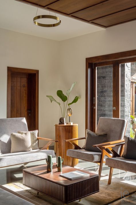 The Living room in the "Hope" residence by The Inside Eye Design Studio based in Kerala features custom-made teak furniture upholstered in Suede fabric. #livingroom #livingroomideas #contemporarylivingroom #Indianhomelivingroom #livingroomdesign #livingroomfurniture #livingroommodern #modernhomes #traditionalliving European Furniture Living Rooms, Kerala Interior Design Living Rooms, Kerala Living Room Designs, Living Room Kerala, Interior Board, Traditional Design Living Room, Lounge Chairs Living Room, Centre Table, Home Design Living Room