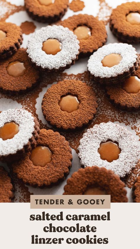 These salted caramel chocolate linzer cookies are made with two rich chocolate cookies sandwiching gooey caramel filling. They're dusted with cocoa powder to make them one of the prettiest holiday cookies you can make. #linzercookies #chocolate #holidaycookies #saltedcaramel | teakandthyme.com Salted Caramel Christmas Cookies, Chocolate Sable Cookies, Chocolate Linzer Cookies, Multigrain Cookies, Sea Salt Caramel Cookies, Caramel Sandwich Cookies, Caramel Cookies Recipes, Salted Caramel Filling, Xmas Recipes