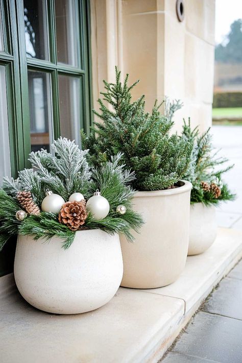 100+  Christmas Planter Ideas Your Front Porch Is Begging For Winter Pots Outdoor Front Doors Modern, Potted Christmas Tree Porch, Poinsettia Front Porch, Christmas Arrangements Outdoor, Faux Winter Planters, Faux Outdoor Christmas Planters, Flower Bed Christmas Decor, Christmas Planter Ideas Outdoor, Porch Pots Ideas Christmas