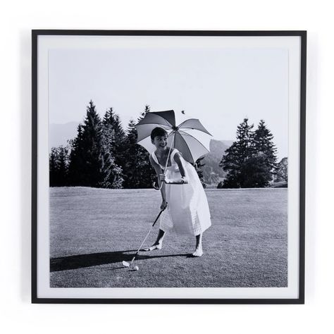 Belgian-born actress Audrey Hepburn takes in a game of gold. Photo courtesy of Getty Images' Hulton Archive – a "living museum" and largest photographic collection in private ownership. Float-mounted and framed within black-finished American maple for a museum-quality look. Handmade in Austin, Texas, each print include Living Museum, Framed Photographs, Four Hands, Hand Art, Audrey Hepburn, Austin Texas, The Professional, Print Images, Art Studio