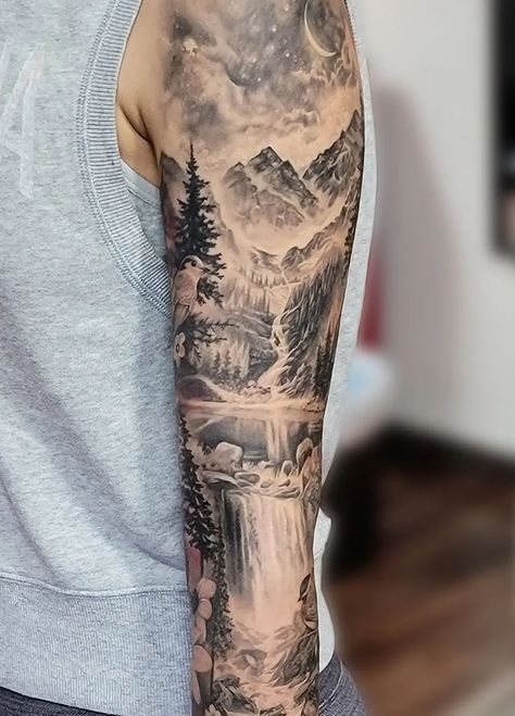 An unbelievably realistic black and grey mountain scenery sleeve tattoo, done by @katarina.heinze. Within this piece is a starry night sky with a crescent moon, trees, a waterfall, rocks, a lake, and of course the rocky peaks of the mountains. Mountain Sleeve Tattoo, Scenic Tattoo, Waterfall Tattoo, Natur Tattoo Arm, Scenery Tattoo, Lake Tattoo, Cream Tattoo, Sky Tattoos, Nature Tattoo Sleeve