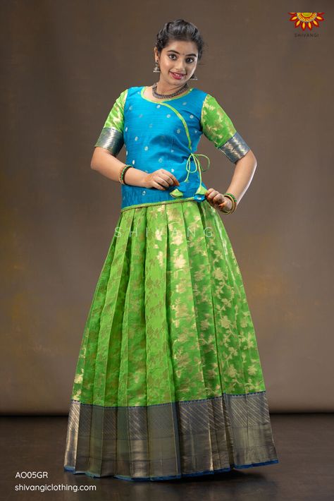 Grapevine Pattu Pavadai | Lehenga !!! Knife pleated skirt highlighted with floral jangla pattern paired with angrakha blouse. A perfect traditional yet trendy Pattupavadai for any special occasion. Click to buy : https://bit.ly/30SZvMv Whatsapp : 8098833000 #Shivangiclothing #newcollection #festiveseason #pattupavadai #ethnic #lehenga #kidsfashion #shoponline #instafashion #shopnow #diwalicollection #coimbatore #girlswear Pattu Pavadai Designs For Adults, Pattu Skirt And Blouse, Saree To Pattu Pavadai, Simple Pattu Pavadai Designs, Pattupavadai Designs For Women, Pattu Pavadai Designs Women, Pattu Langa Blouse Designs, Pattu Pavada Women, Lehengas Blouse