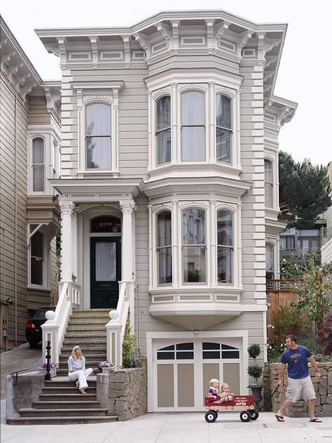 This restored rowhouse embraces this gorgeous dark front door! More home exterior ideas here: http://www.bhg.com/home-improvement/exteriors/curb-appeal/before-and-after-home-exteriors/?socsrc=bhgpin070614restoredrowhouse&page=9 Victorian House Colors, Stucco Siding, Exterior House Colors Stucco, Siding Options, Victorian Style Homes, Home Exterior Makeover, Beautiful Churches, Bay Windows, Exterior Makeover