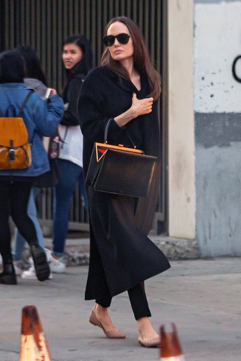 Angelina Jolie Is Obsessed With This Bag Brand Angelina Jolie Street Style, Black Monochromatic Outfit, Old Celine, Angelina Jolie Style, Monochromatic Outfit, Long Black Coat, Black Winter Coat, Phoebe Philo, Park Shin Hye