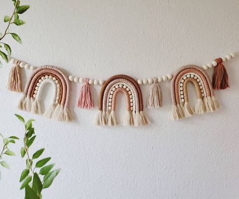 25+ Boho Rainbow Nursery Ideas You'll Swoon Over - One Sweet Nursery Macrame High Chair Banner, Boho Rainbow Garland, Boho Kids Chandelier, Yarn Nursery Decor, Wood Rainbow Decor, Mauve Rainbow Nursery, Macrame With Wool Yarns, Rustic Rainbow Nursery, Boho Rainbow Office Decor