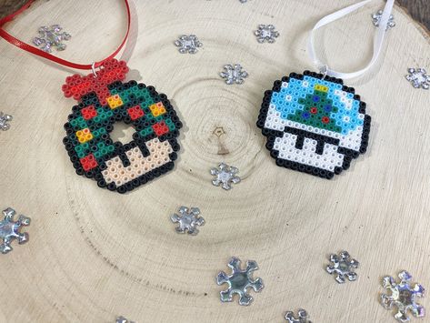 Super Mario Santa Christmas Decorations | Perler Bead Ornaments | Nerdy Tree Ornaments | Video Game Christmas Theme | Mario Mushroom Santa | Kids Stocking Stuffers | Mushrooms Approx 2.5 in x 2 in Please select Red, Green or Both from drop down at checkout along with your finish choice. Ornaments come with attached ribbon for hanging, colors will be either green, red or white at random unless specified. If you would like a specific color of ribbon please just let me know and I would be happy to Perler Bead Ornaments, Video Game Christmas, Perler Bead Designs, Christmas Perler Beads, Bead Ornaments, Perler Creations, Pearl Beads Pattern, Art Perle, Diy Perler Bead Crafts