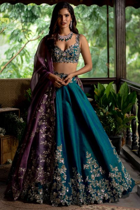 Featuring an emerald green lehenga in raw silk base with sequins embroidery. It is paired with a matching blouse and a contrasting purple organza dupatta.  FIT: Fitted at bust and waist. COMPOSITION: Raw silk, Organza. CARE: Dry clean only. Purple Lehenga, Pengantin India, Raw Silk Lehenga, Anushree Reddy, Best Designer Dresses, Wedding Lehenga Designs, Green Lehenga, Gaun Fashion, Half Saree Designs