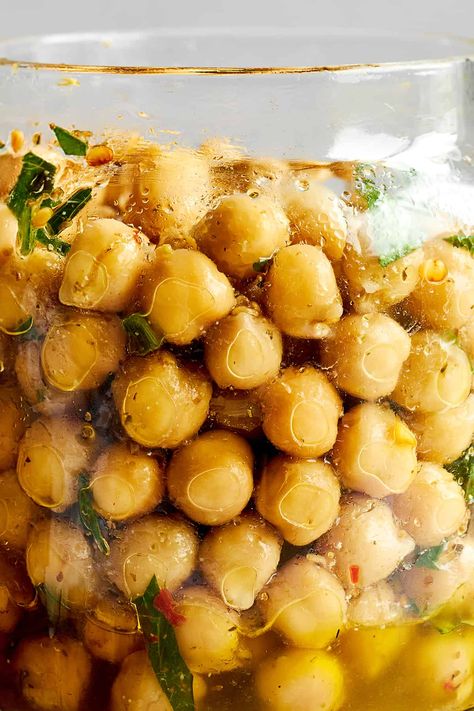 Prepare this marinated chickpeas recipe with simple ingredients, and keep it on hand to add flavor to salads, soups, and more! Food Dolls Marinated Chickpeas, Chickpeas In Salad, Marinated Chickpeas Recipe, Marinated Garbanzo Beans, Marinated Chickpea Salad, Pickled Chickpeas, Marinated Beans, Marinated Chickpeas, Recipes Beans