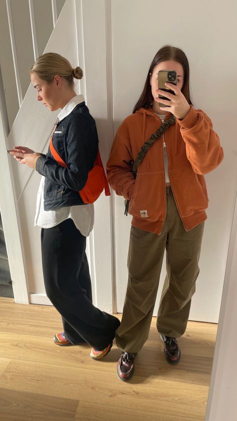 Twins, outfit, ootd, stussy, vest, hoodie, orange, street style, mirror picture, denim, parachute pants, loafers, salomon, crossbody bags, 2023 Pants With Loafers, Stussy Vest, Orange Street Style, Crossbody Bags 2023, Hiking Vibes, Twins Outfit, Vest Hoodie, Mirror Picture, Style 2023