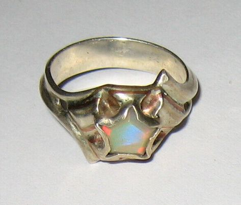 NATURAL SOLID AUSTRALIAN OPAL (HYDROPHANE CRYSTAL) IN STERLING SILVER RING WITH BRASS AND COPPER DETAILS   RING DETAIL INSPIRED BY WONDER WOMAN SIZE ~ 6.5 SETTING height ~ 5mm BAND width ~ 4.3mm STONE DETAIL SIZE ~ 7mm PENTAGON NATURAL SOLID AUSTRALIAN CRYSTAL OPAL  THIS ONE OF A KIND (NEVER CAST) SILVER RING HAS A LOW PROFILE DESIGN TO PREVENT CATCHNG AND SNAGGING. INSPIRED BY WONDER WOMAN MADE WITH THE "PERSON ON THE GO" IN MIND. WE BELIEVE YOU DON'T HAVE TO SACRAFICE FUNCTION FOR FASSION SO LET US OFFER YOU BOTH.  CLASSY AND HAND CRAFTED IN THE USA  (BY E.N. OF META STONE DESIGN) COMBINED SHIPPING IS ALWAYS WELCOME AND YOU CAN SHOP WITH US FOR UP TO 21 DAYS ON ONE INVOICE!   STANDARD SHIPPING STRUCTURE FOR ALL LISTINGS: ------------------------------------ USA ~ STORE LISTINGS: FREE SHI Galaxy Jewelry Rings, Opal Star Ring, Stone Setting Jewelry Design, Resin And Metal Jewelry, Raw Silver Jewelry, Soldered Metal Jewelry, Silver Clay Ring, Soft Solder Jewelry, Selenite Ring