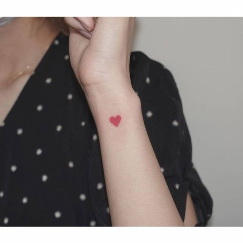 Minimalist red heart tattoo on the wrist. Heart Tattoo Black, Hand Heart Tattoo, Red Heart Tattoo, Small Colorful Tattoos, Heart Tattoo On Finger, Tattoo On The Wrist, Love Heart Tattoo, Heart Tattoo Wrist, Red Heart Tattoos