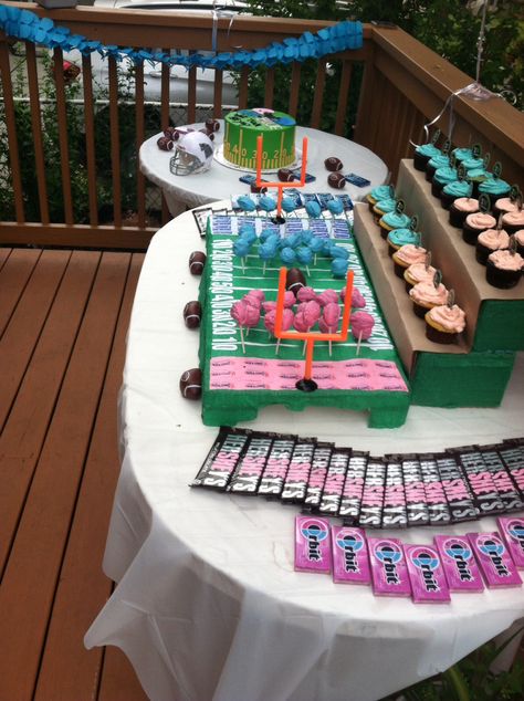 Gender reveal - football theme dessert table! A football field was created with styrofoam and streamers for the football shaped cakepops Bleachers were made out of cardboard for the cupcakes Cupcakes had a football wrapper and an I love football topper Hershey bars were genderized using nail polish Packs of orbit gum used for more color emphasis There was also blue raspberry and pink lemonade in 2 beverage dispensers All tables had a football field runner in the middle Footballs And Tutus Gender Reveal, Football Or Pompoms Gender Reveal, Football And Pom Poms Gender Reveal, Touchdowns Or Pom Poms Gender Reveal, Gender Reveal Football Or Pom Poms, Touchdowns And Tutus Gender Reveal, Gender Reveal Ideas Football Theme, Quarterback Or Cheerleader Gender Reveal, Footballs Or Pom Poms Gender Reveal