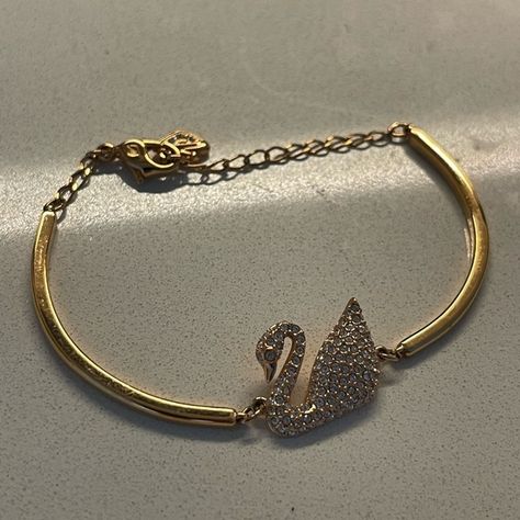 swarovski swan gold bangle bracelet Swarovski Swan Bracelet, Swarovski Jewelry Gold, Swan Bracelet, Luxury Wishlist, Swarovski Swan, Teen Fame Dr, Swarovski Bracelet, This Is My Life, Minimalist Bracelet