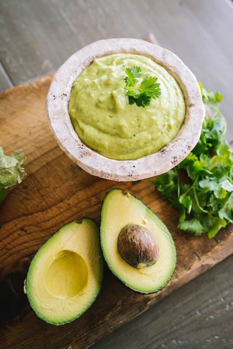 white mini molcajete filled with Salsa de Guacamole or Guacamole Salsa with a side of avocados and cilantro Tomatillo Avocado Salsa, Creamy Avocado Salsa, Avocado Tomatillo Salsa, Bueno Recipes, Salsa Salsa, Serrano Peppers, Guacamole Salsa, Homemade Salsa Recipe, Hispanic Kitchen