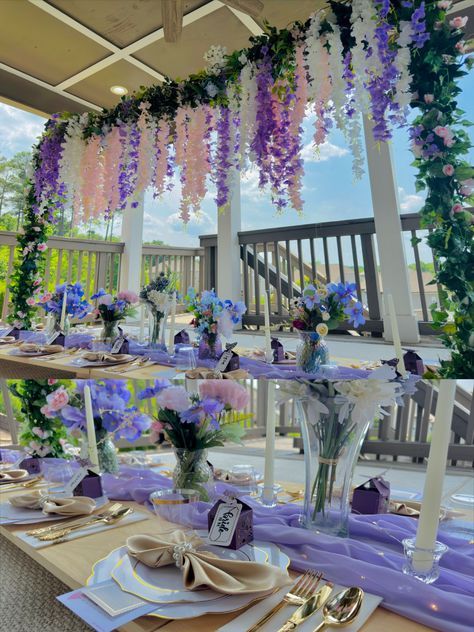 Floor table summer setup with pink, white, and purple wisteria looming over in a pipeline setup, twined with floral and eucalyptus garlands Purple Tea Party, Teacup Party, Fairy Picnic, Pink Graduation Party, 35 Birthday, Bridgerton Party, Adult Tea Party, Diy Tea Party, Graduation Party Table