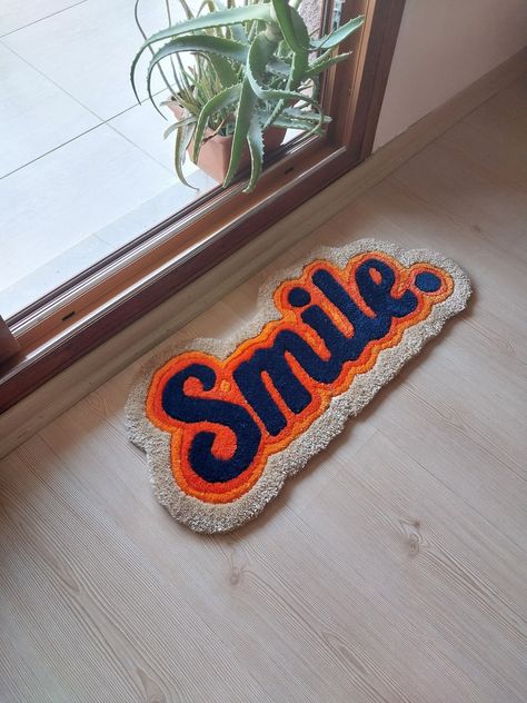 "\"Smile Rug Design\" This product is made of acrylic and cotton yarn and presented to your liking. We kindly ask you to look at the dimensions of the product before making a purchase. FAST WORLDWIDE SHIPPING  Thanks in advance for your comments." Funky Rugs Living Room, Smile Rug, Tufting Rug, Tufting Ideas, Tufted Rug Design, Funny Tufted Rug, Tufted Rug How Yo, Self Love Club Tufted Rug, Word Tufted Rug