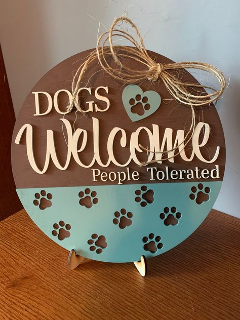 "We all know how it is...we love those pets! Why not show it off with a fun sign! This dogs welcome people tolerated sign is made using 1/8\" wood layered to complete this gorgeous and fun sign! It is roughly 11\" in diameter and comes with a stand if you choose to use it!" Glowforge Pet Projects, Dogs Welcome People Tolerated, Pet Wreath, Twine Bow, Fun Sign, Stencils For Wood Signs, Door Signs Diy, Diy Wooden Projects, Wood Dog