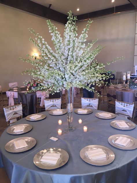 White delphinium centerpiece  #weddingflowers #centerpiece Delphinium Centerpiece Wedding, Delphinium Centerpiece, White Delphinium Centerpiece, Blue Delphinium Centerpiece, Hydrangea And Delphinium Centerpiece, White Delphinium Arrangement, White Floral Bouquey For Eigfel Tower Vase, Bling Wedding Decorations, Tall Flower Centerpieces