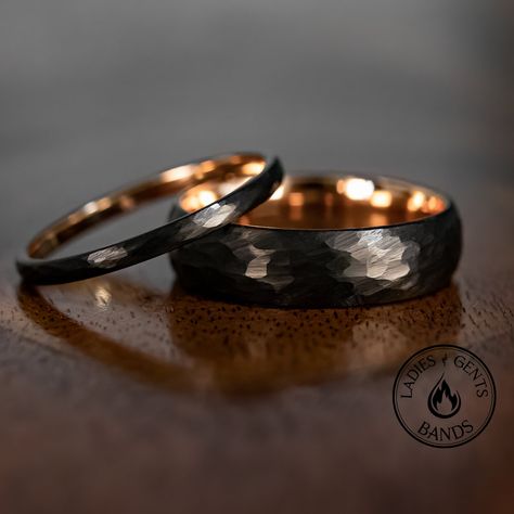 Your wedding ring set order includes + One 6mm Black Hammered Obsidian-styled tungsten Wedding Band with Rose Gold inlay + One 2mm Black Hammered Obsidian-styled tungsten Wedding Ring with Rose Gold inlay + Both Come inside Wax Sealed Ring Boxes. Limited Time: Free Matching Set of Black Silicone Bands w/ Order. *Durable - Incredibly Scratch-Resistant to always look great. *Comfort-fit & Weighty - Designed to fit well and feel good in your hand. *Made to order - Every ring we ship is unique and o His Her Wedding Rings, Him And Hers Wedding Rings, Matching Bands His And Hers, Mens Tungsten Rings, Wedding Ring Sets Black, Gold And Black Wedding Ring, Mens Rings Fashion Style, Black Wedding Bands For Men, Black Wedding Rings For Men