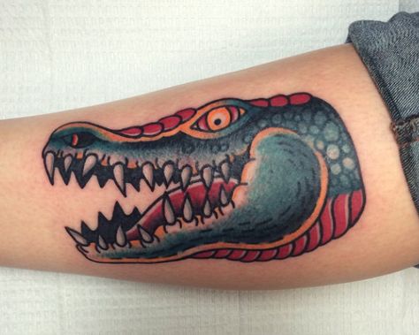 Traditional crocodile head tattoo by Matt Nemeth in RVA. Crocodile Head Tattoo, Traditional Crocodile Tattoo, Traditional Tattoo Cover Up, Alligator Tattoo, Crocodile Tattoo, Crocodile Head, Peter Pan Tattoo, Hook Tattoos, Head Tattoo