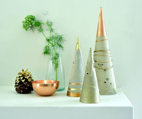 Use these stylish cement trees to create an eye-catching mantelpiece display What you’ll need: Cement (we used a 5kg bag) Plastering sand 2 buckets Gravel or sand: to support the cones when drying Small spade for mixing Scissors or knife Heavy duty plastic/acrylic sheeting: it needs to be flexible enough to roll up but also remain strong enough to hold the cement mixture. We used an A0 size sheet from The Plastics Workshop. An old laminated poster could also possibly do the trick. P… Chalk Paint Wax, Paper Towel Tubes, Plastic Pumpkins, Hardware Cloth, Copper Paint, Alternative Christmas Tree, Hexagon Coasters, Heart Themed, Mini Christmas Tree