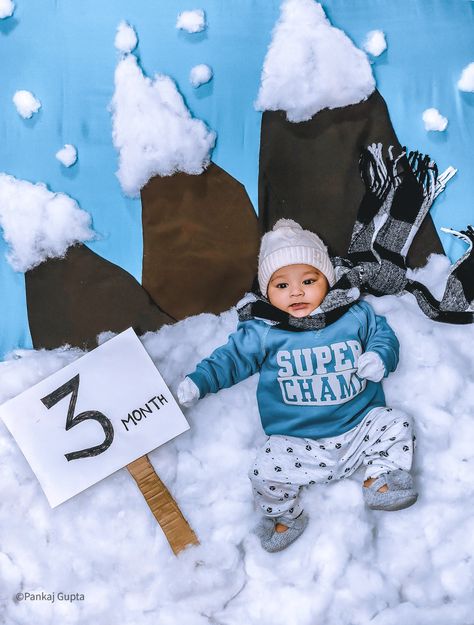 In this pic, we use brown colour cloth for mountain and blue colour cloth as a background. After that, we have used cotton for ground & top of the mountain. If you are looking for more interesting ideas then visit my profile. Winter Season Photography, Winter Baby Shoot Ideas, Baby Winter Photoshoot Ideas, 5 Month Baby Photoshoot Ideas, Winter Theme Photoshoot, Baby Winter Photoshoot, 3months Baby Photoshoot Ideas, Winter Theme Baby Photoshoot, Winter Baby Photoshoot Ideas